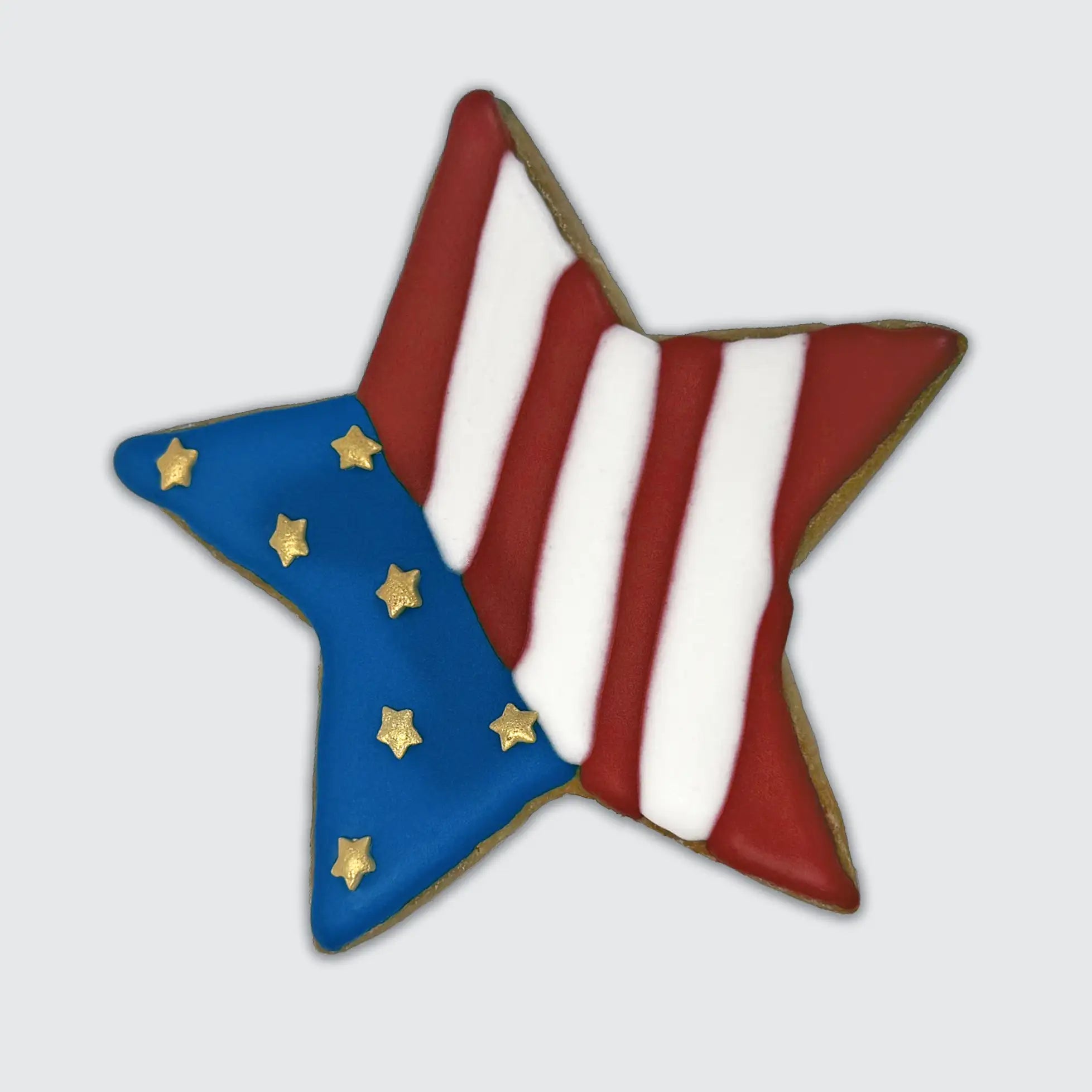 Star-shaped sugar cookie decorated with red and white stripes and a blue field with gold stars, resembling the American flag.