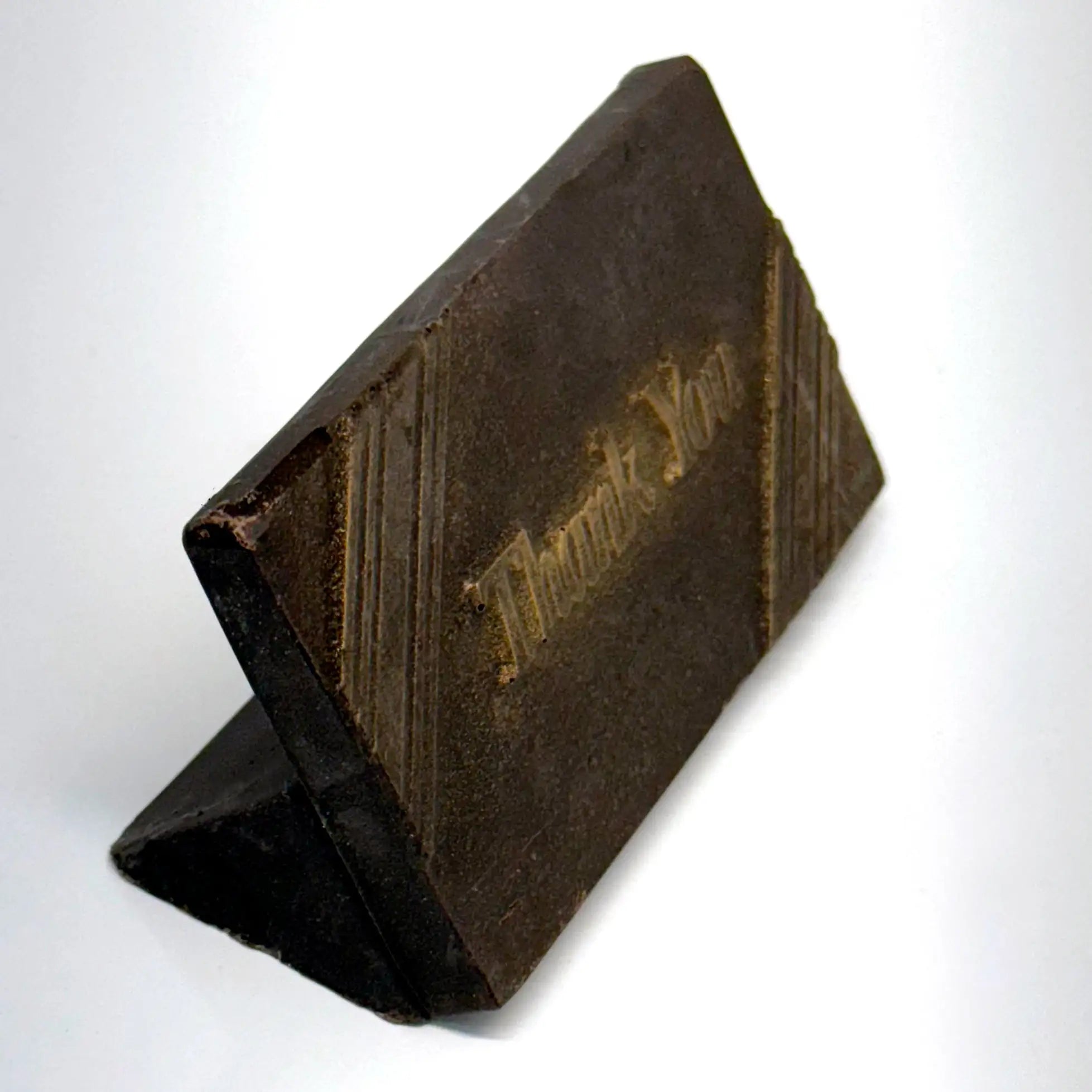 A side view of an elegant rectangular chocolate favor features rich brown finish accented with a delicate touch of gold dust for a luxurious shimmer. Subtle diagonal lines frame the design, while the words “Thank You” are gracefully embossed in the center.
