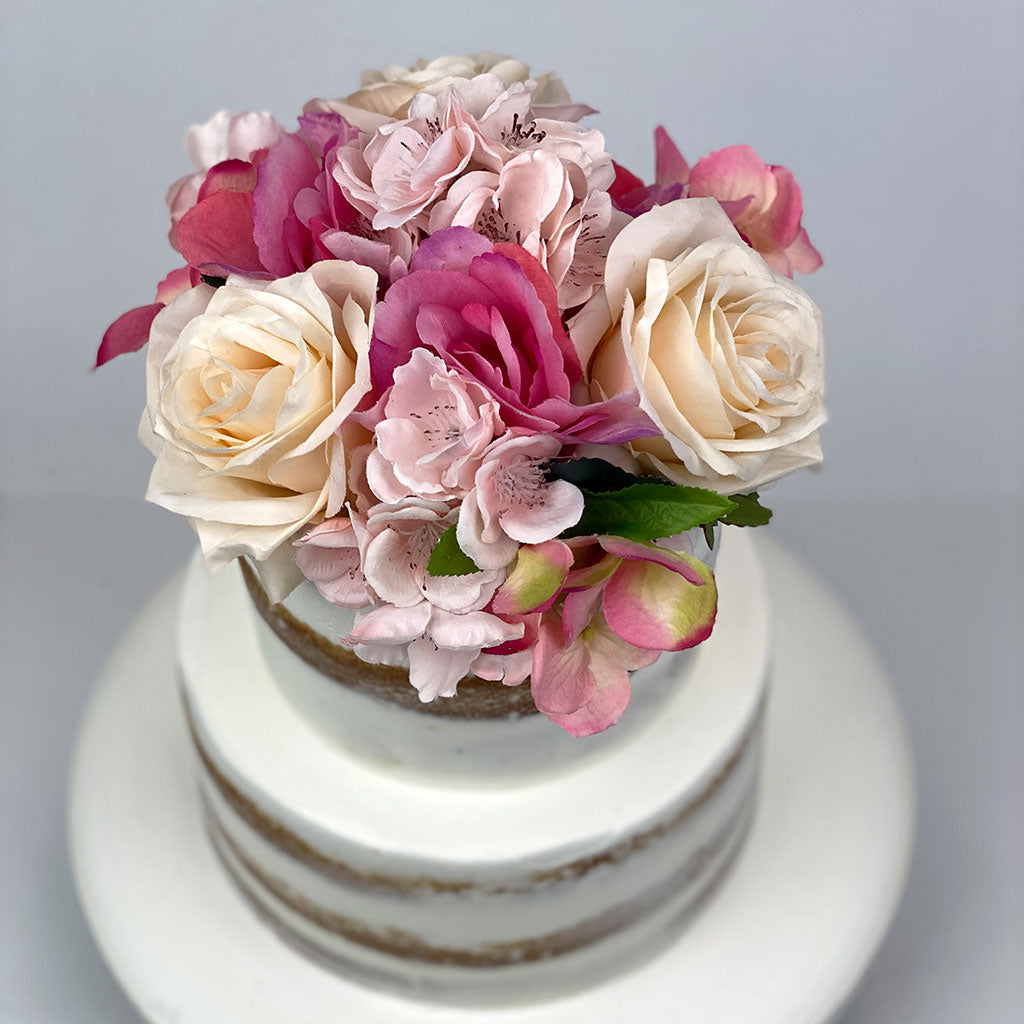 Naked Tiered Cake with flowers on the top tier
