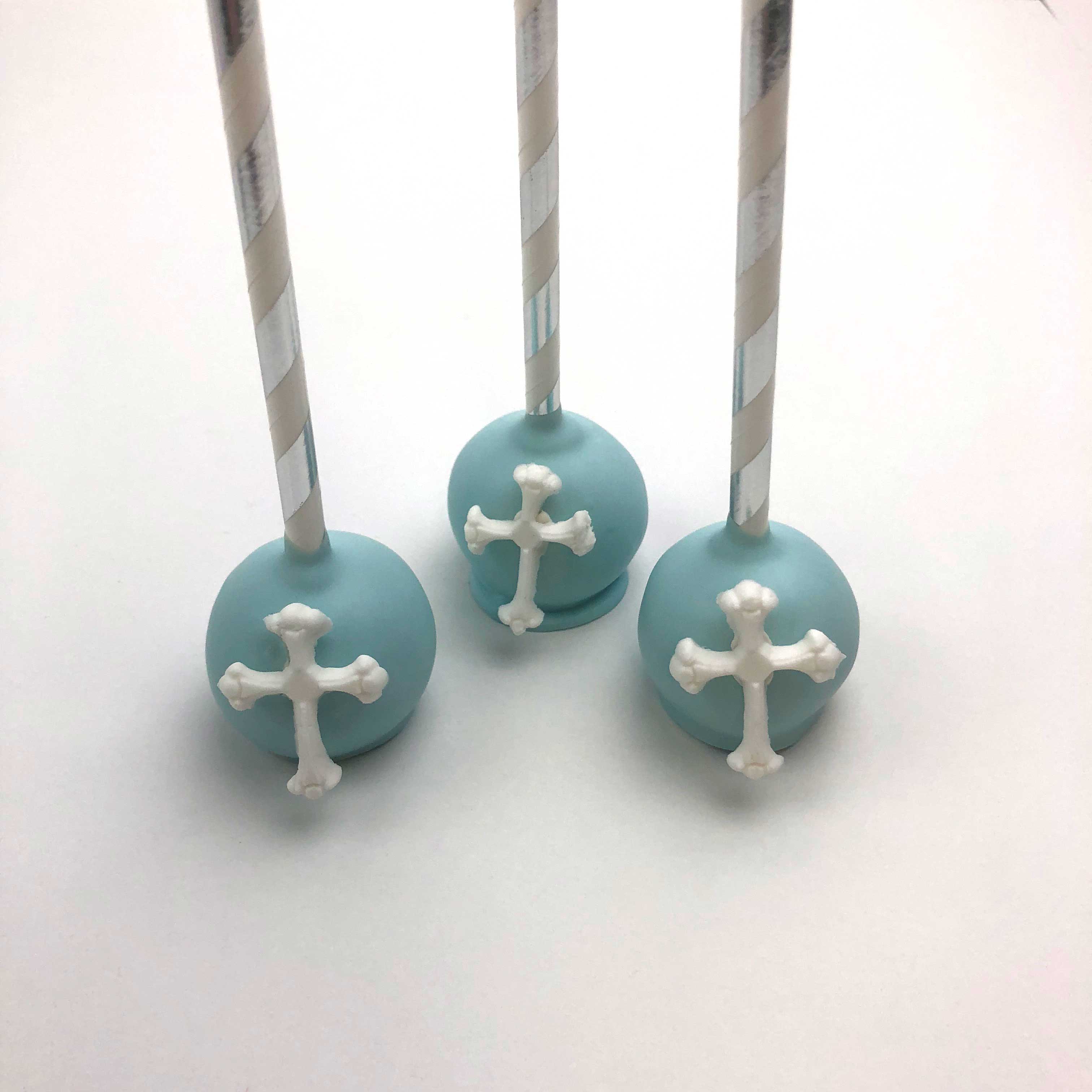 Three Blue Cake Pops, each has a white Cross