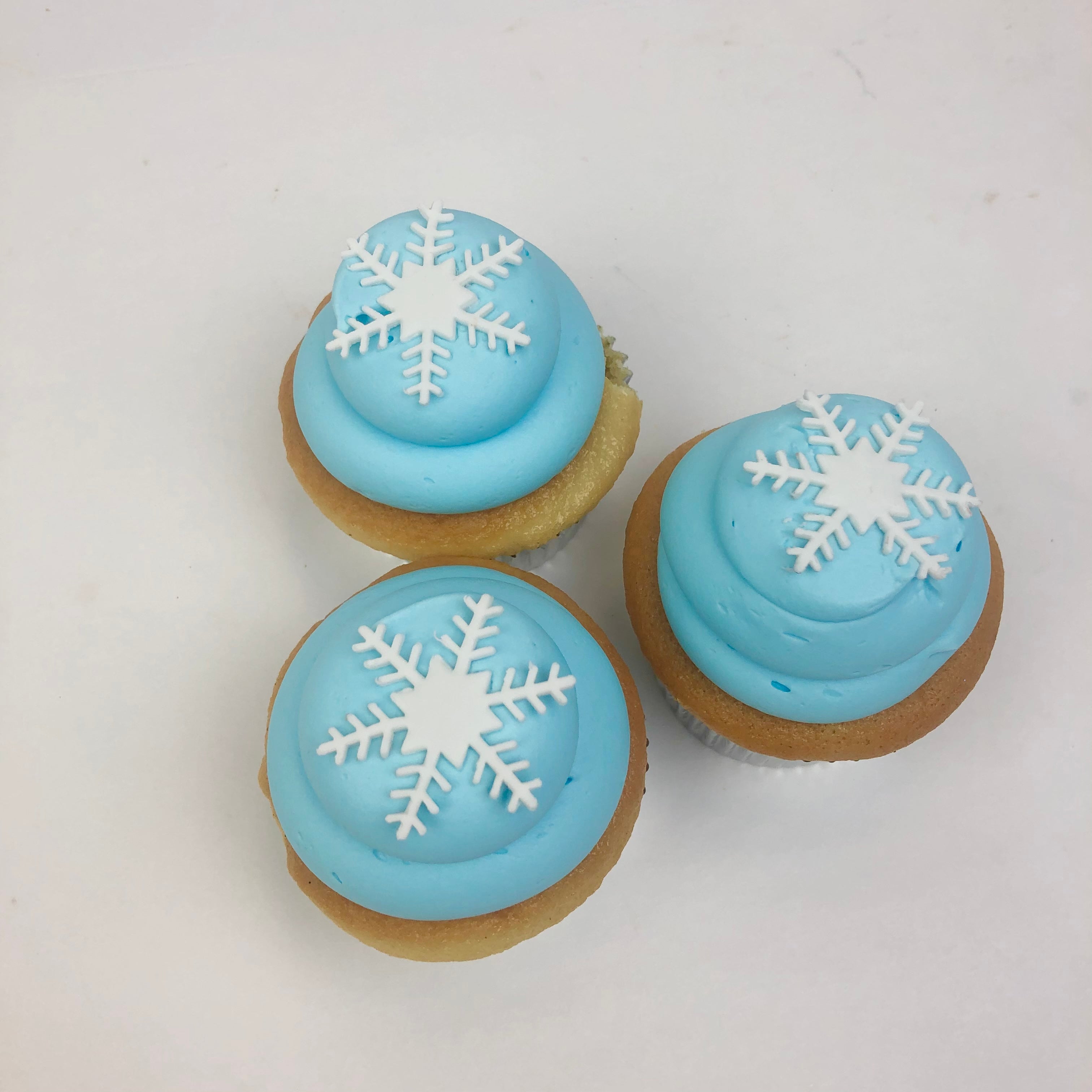 Three Blue Buttercream Swirl with white Fondant Snowflake