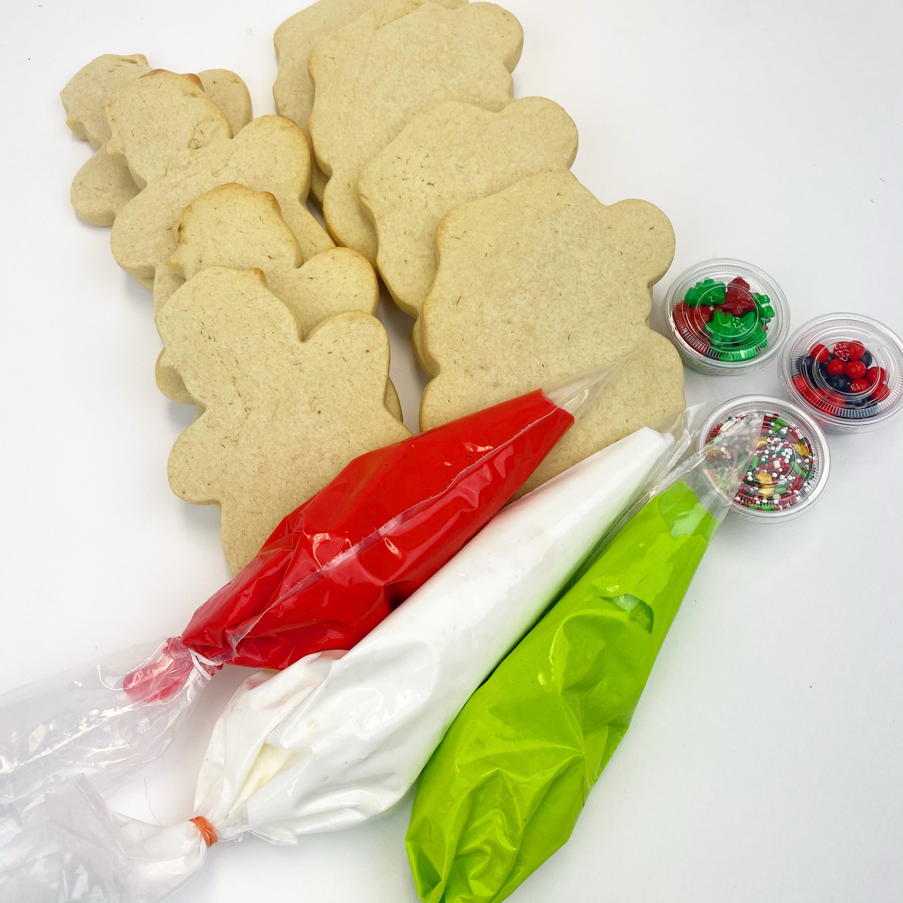 4 Large santa face and 4 large snowman sugar cookies with red, green, white royal icing to decorate yourself. Also sprinkles for an added touch