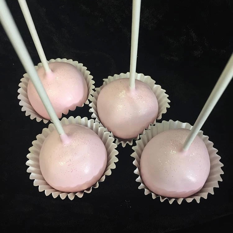Four light pink cake pop with edible glitter.