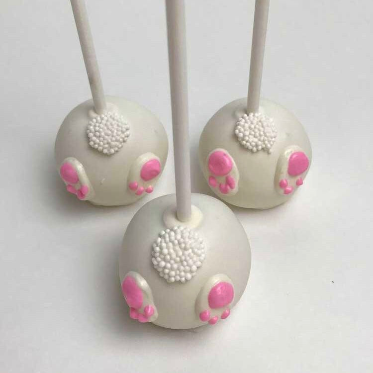 Three white Bunny Cake Pops with pink paws.