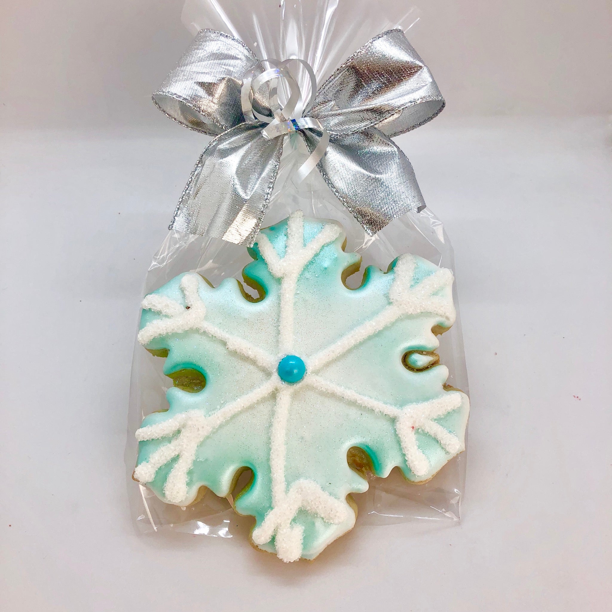 Snowflake Sugar Cookie wrapped in cellophane with a ribbon