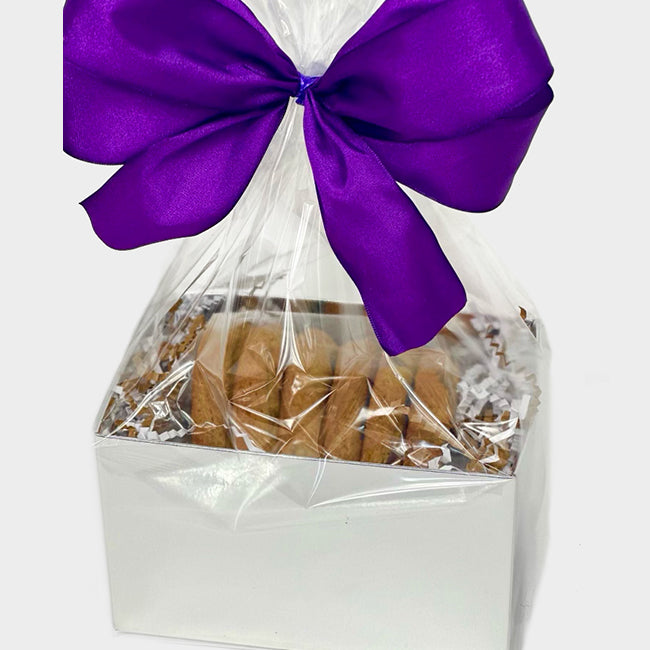 White box of cookies wrapped in cellophane with a ribbon