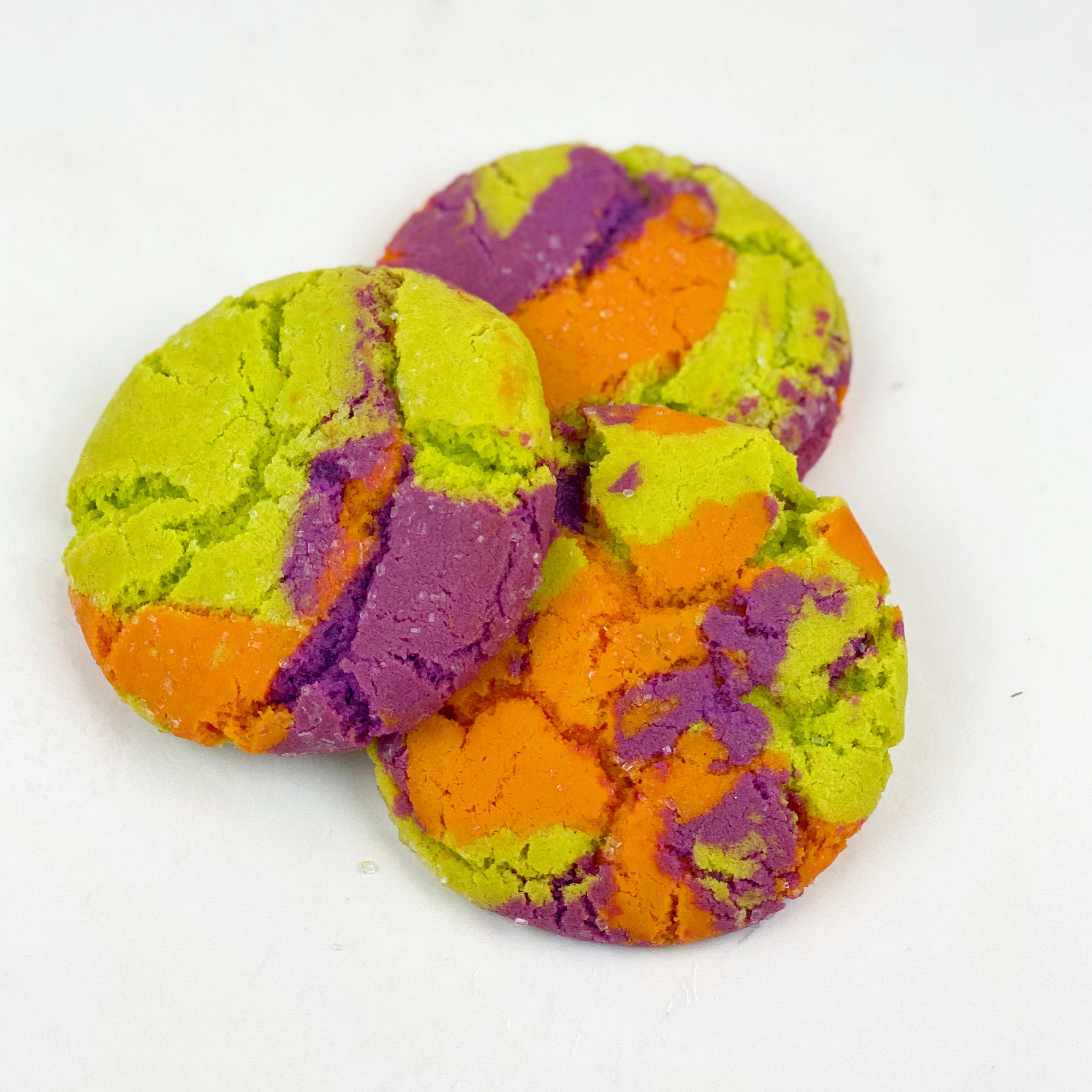 Our delicious sugar cookie dyed for Halloween in 3 colors...orange, purple and lime green ... baked with crystal sugar on top