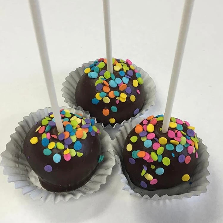 Three cake pops dipped in dark chocolate then topped off with multi-colored confetti sprinkles