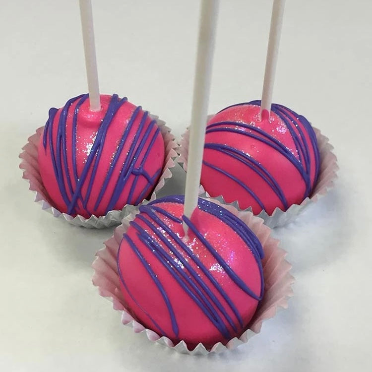 Three cake pops dipped in hot pink chocolate and drizzled with lavender chocolate then a sprinkle of edible glitter