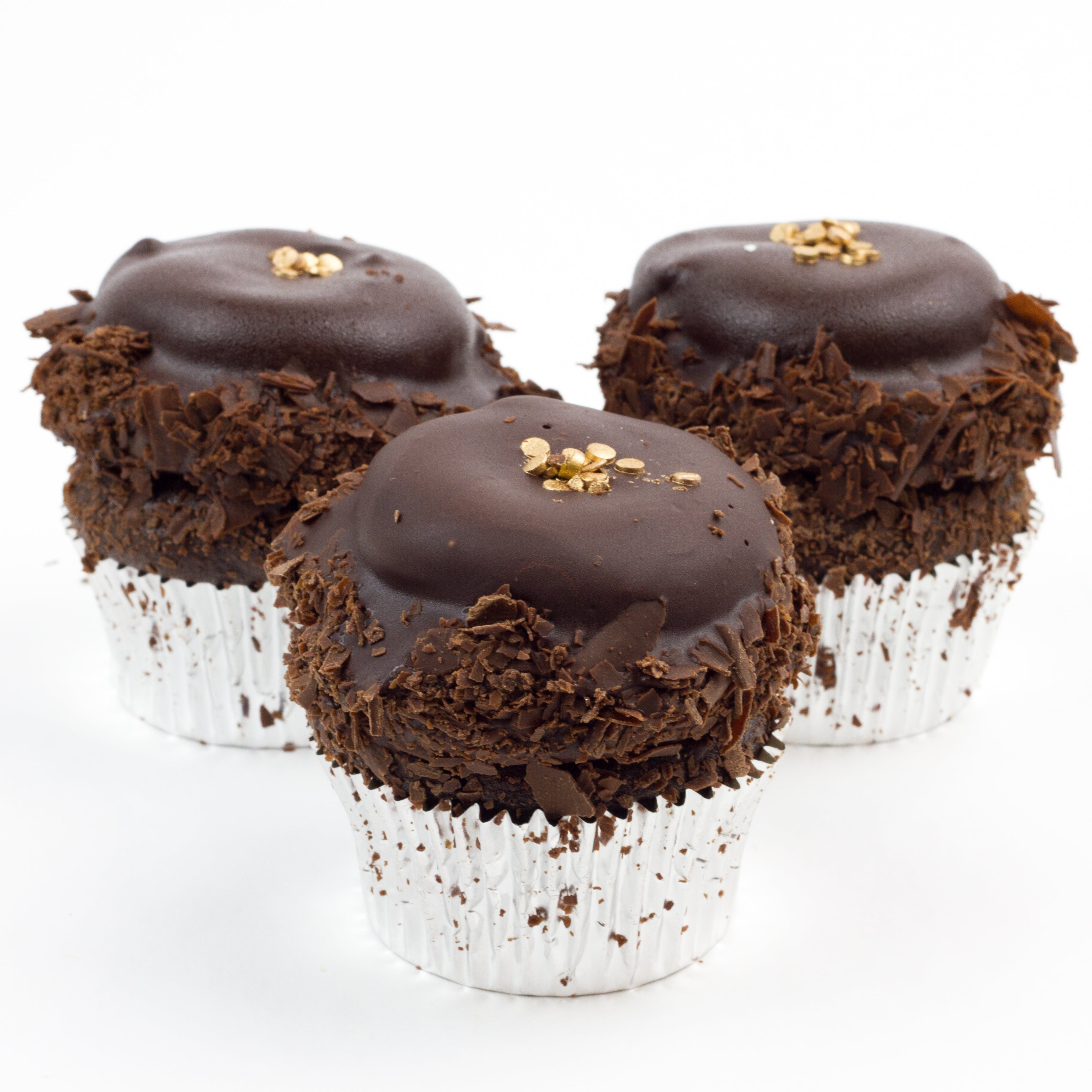Three Chocolate Overload cupcakes topped with a nice swirl of triple fudge that’s dipped in chocolate for a nice chocolate shell and garnished with fine chocolate shavings and a little gold for color.