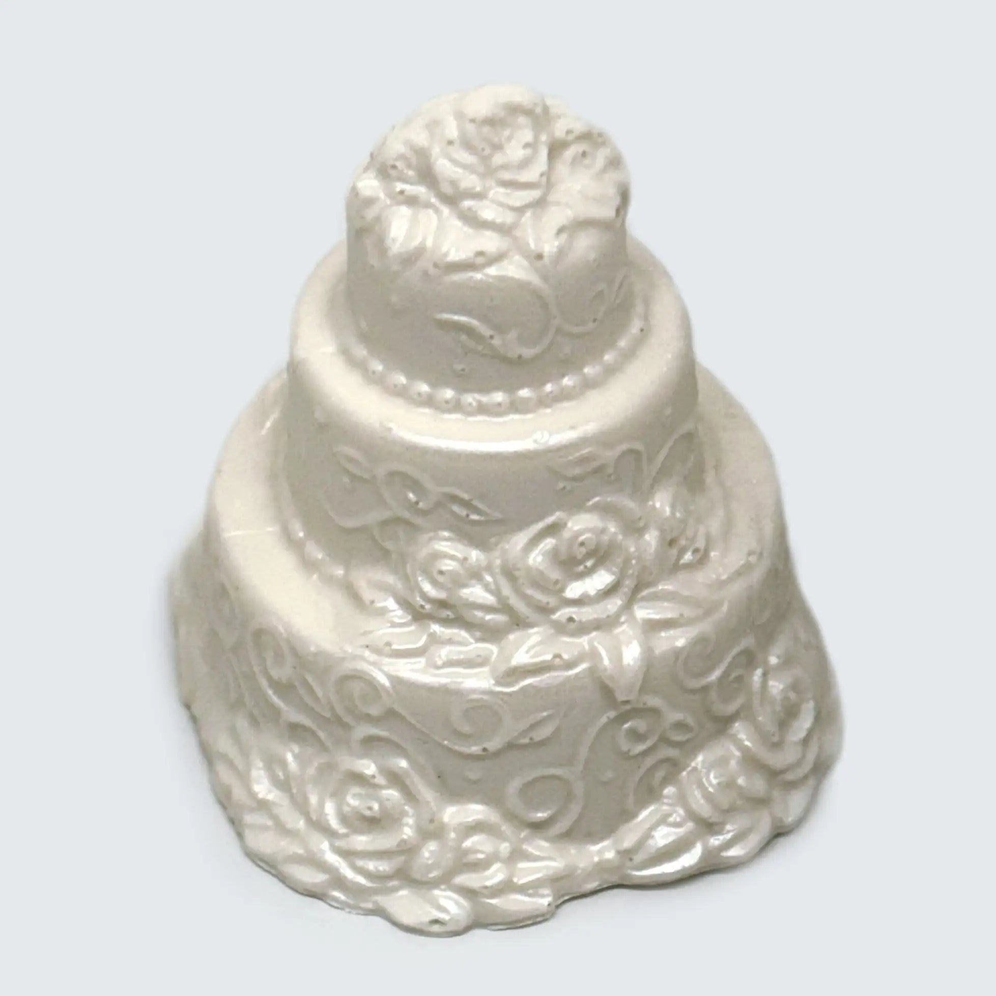A white three tier Small Chocolate Wedding Cake decorated with white flowers and pearls