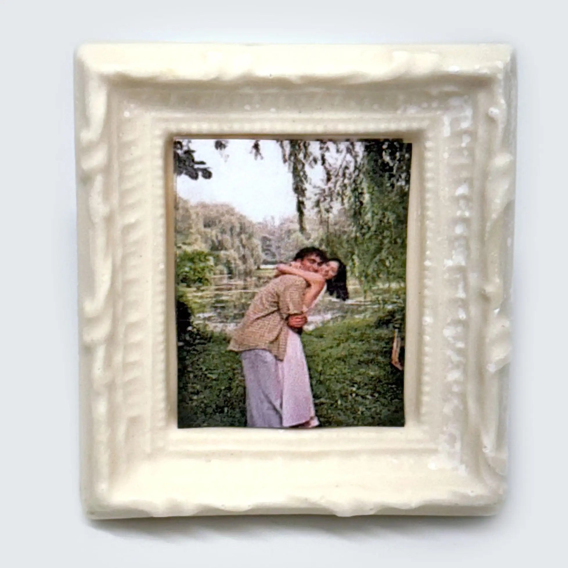 Front view of a white chocolate frame with accents in white, decorated with customer photo on edible image paper