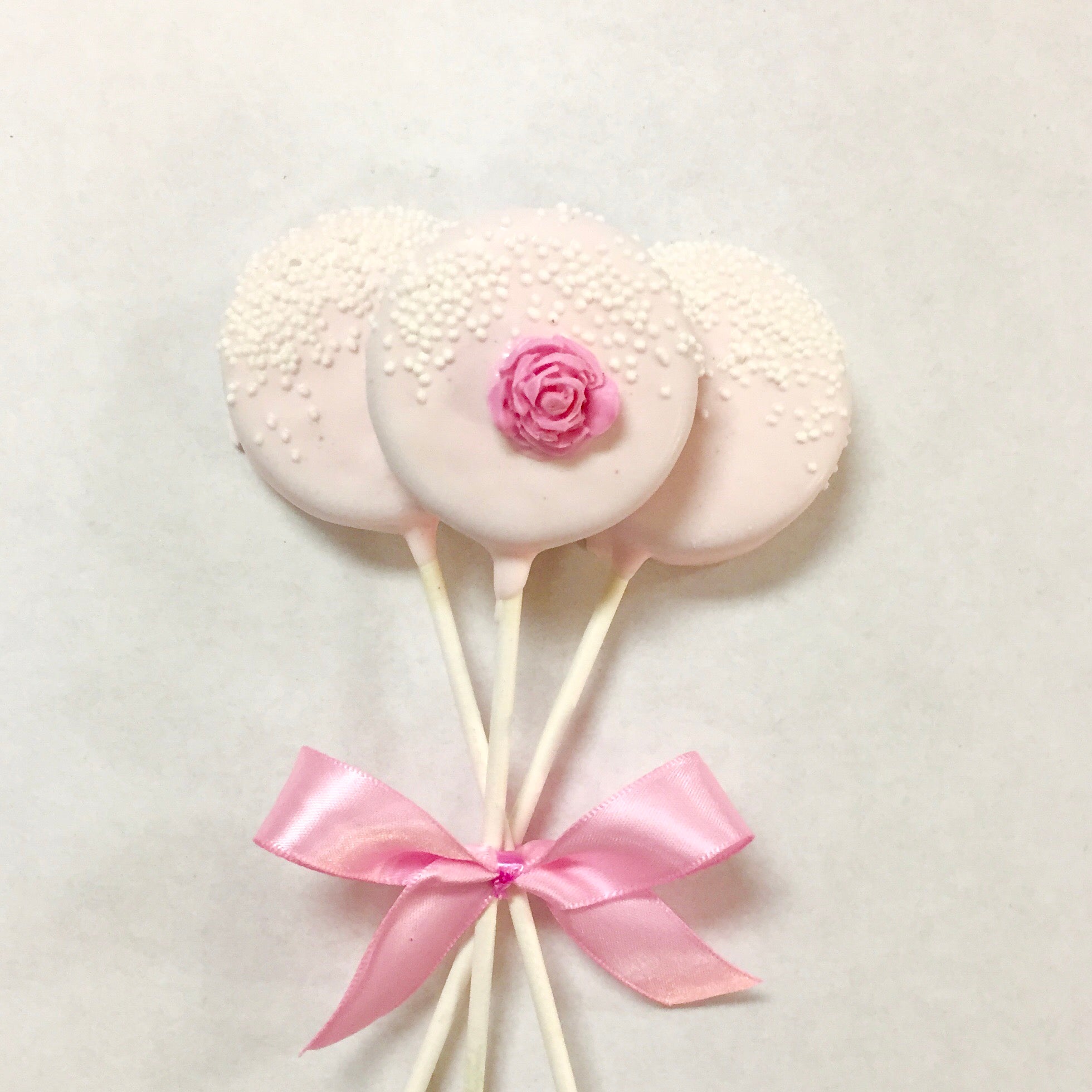 Light Pink Chocolate covered Oreos with nonpareils and a pink chocolate rose