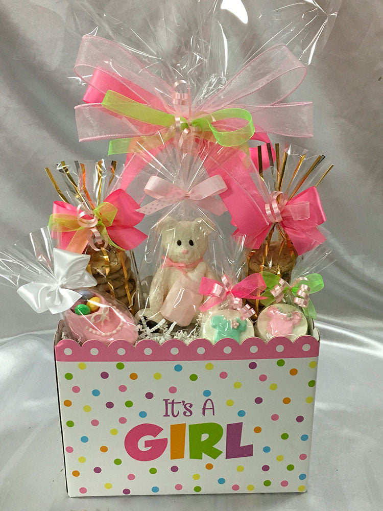 It's A Girl git box: 2 bags of mini chocolate chip cookies, solid 3D white chocolate bear, chocolate baby bootie, and 2 chocolate covered Oreos all wrapped in cello and tied with Rosa Wrap satin bow.  