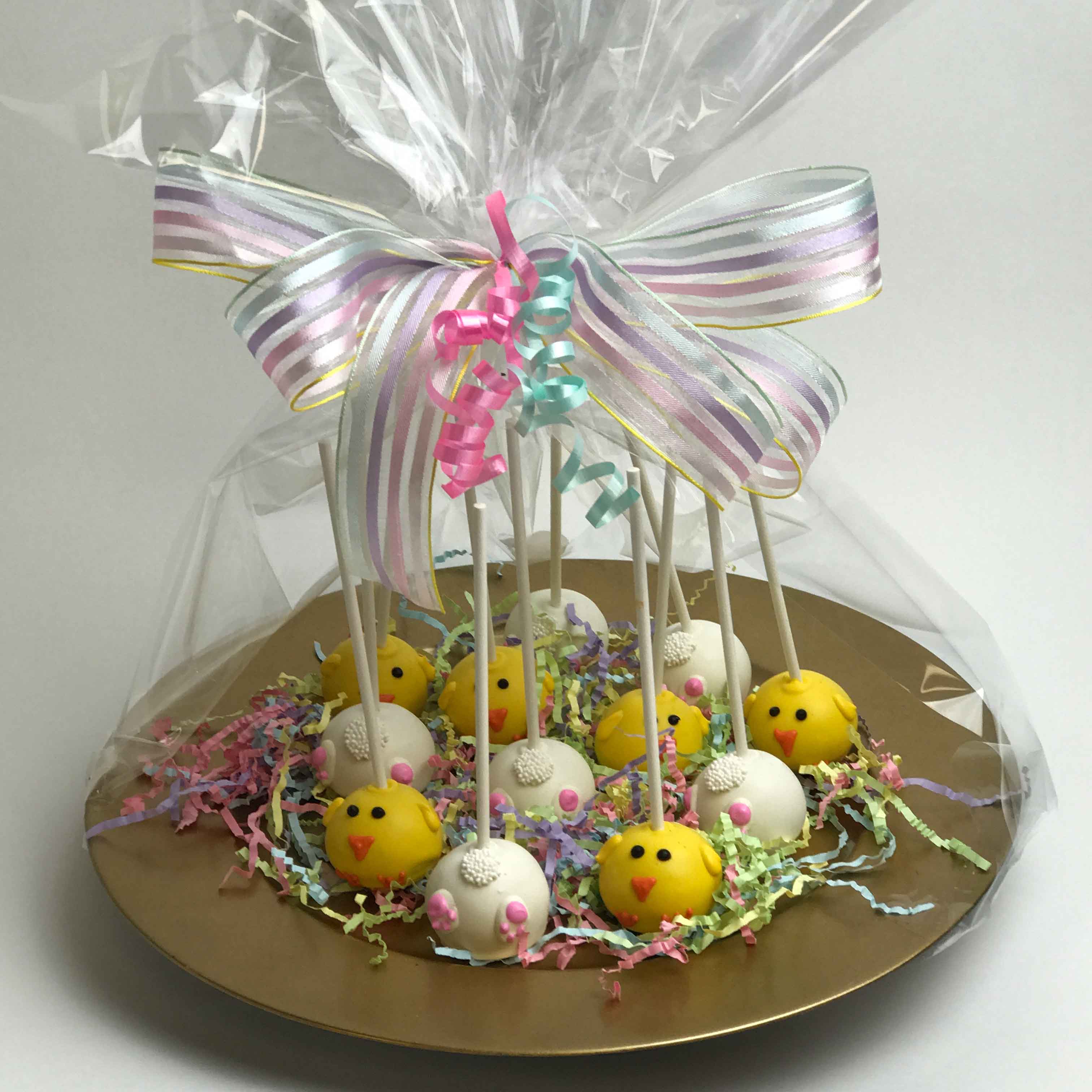 Bunnies and chicks Easter Cake Pop Platter inside a golden platter, warped in cellophane with ribbons