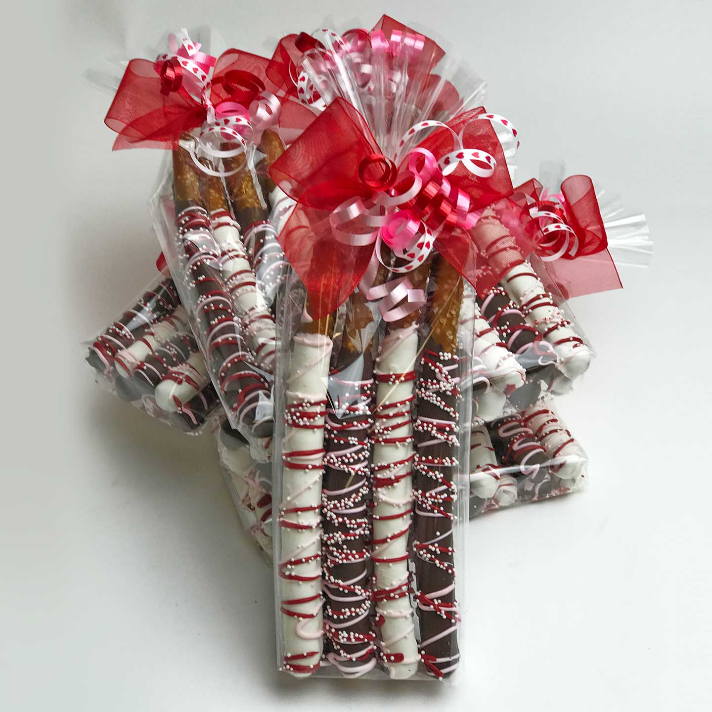 Valentine’s Chocolate Covered Pretzels wrapped in cellophane with a ribbon