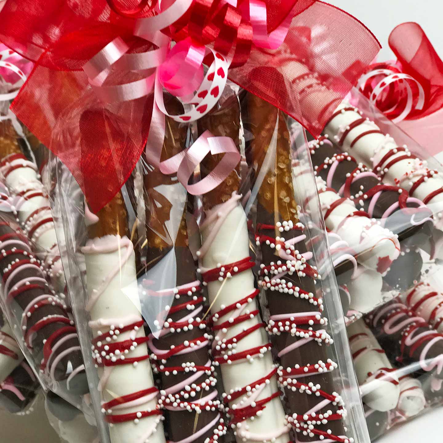 Valentine’s Chocolate Covered Pretzels wrapped in cellophane with a ribbon