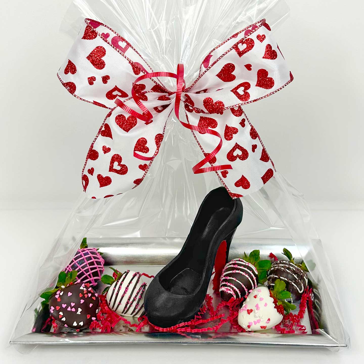 Valentine's Day Stilettos and Chocolate Strawberries on a tray, wrapped with cellophane and a big bow with hearts