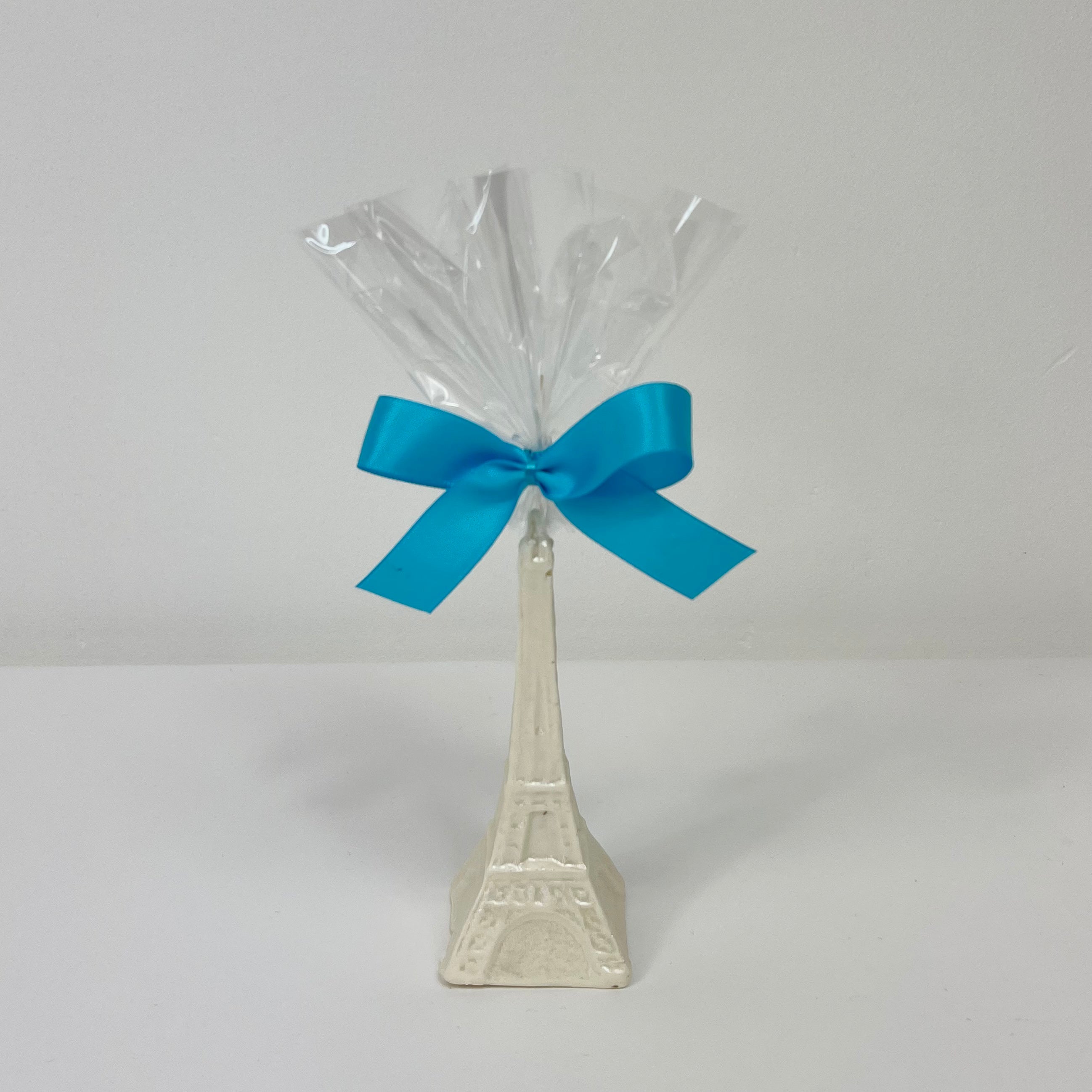 Solid Pearlized White Chocolate Eiffel Tower wrapped in cellophane with a ribbon