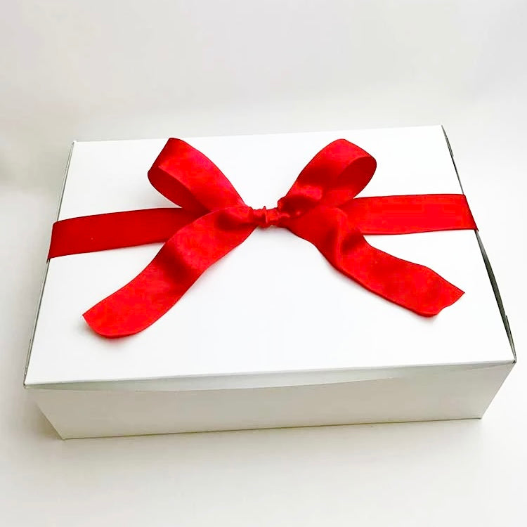 A white box tied with a red satin bow