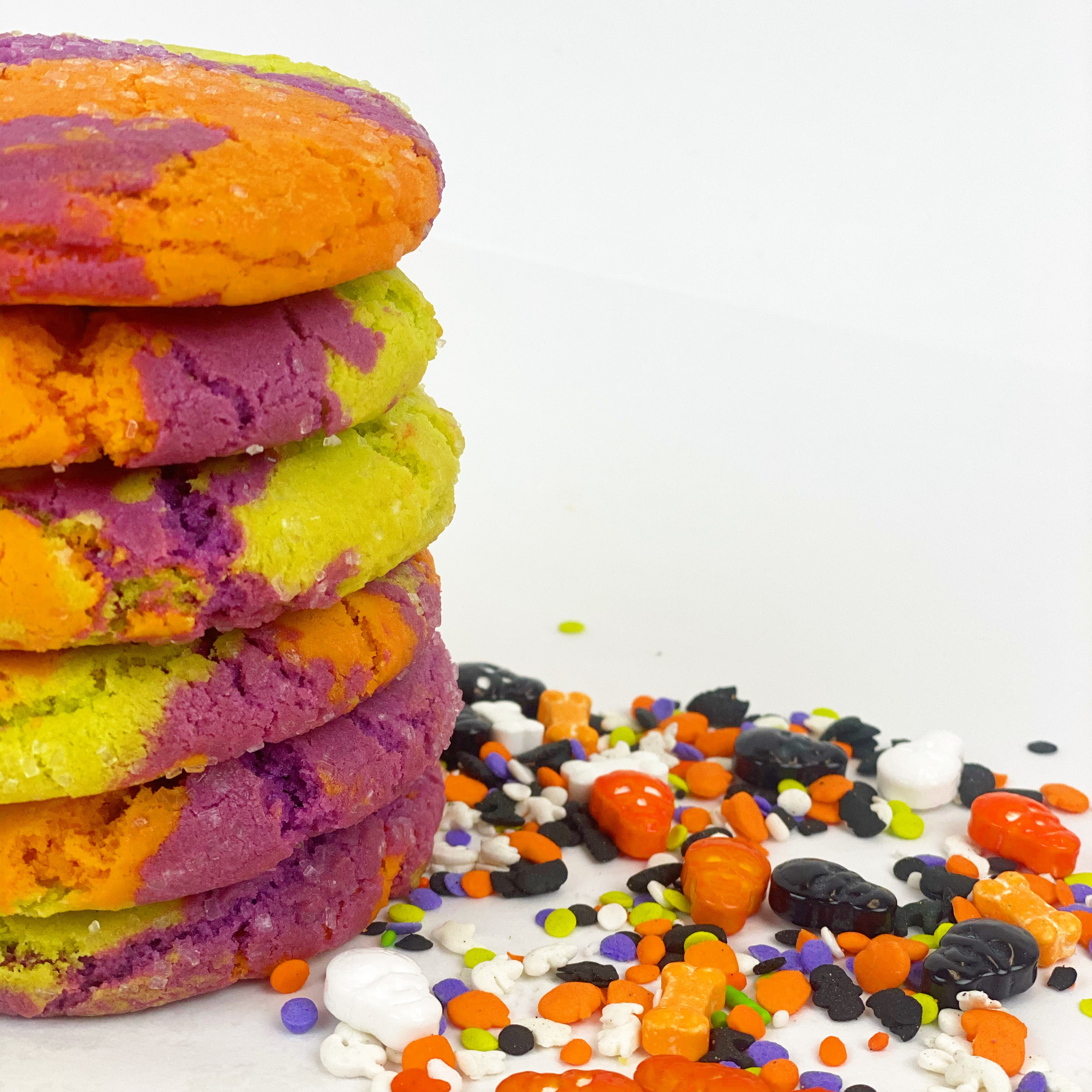 Our delicious sugar cookie dyed for Halloween in 3 colors...orange, purple and lime green ... baked with crystal sugar on top