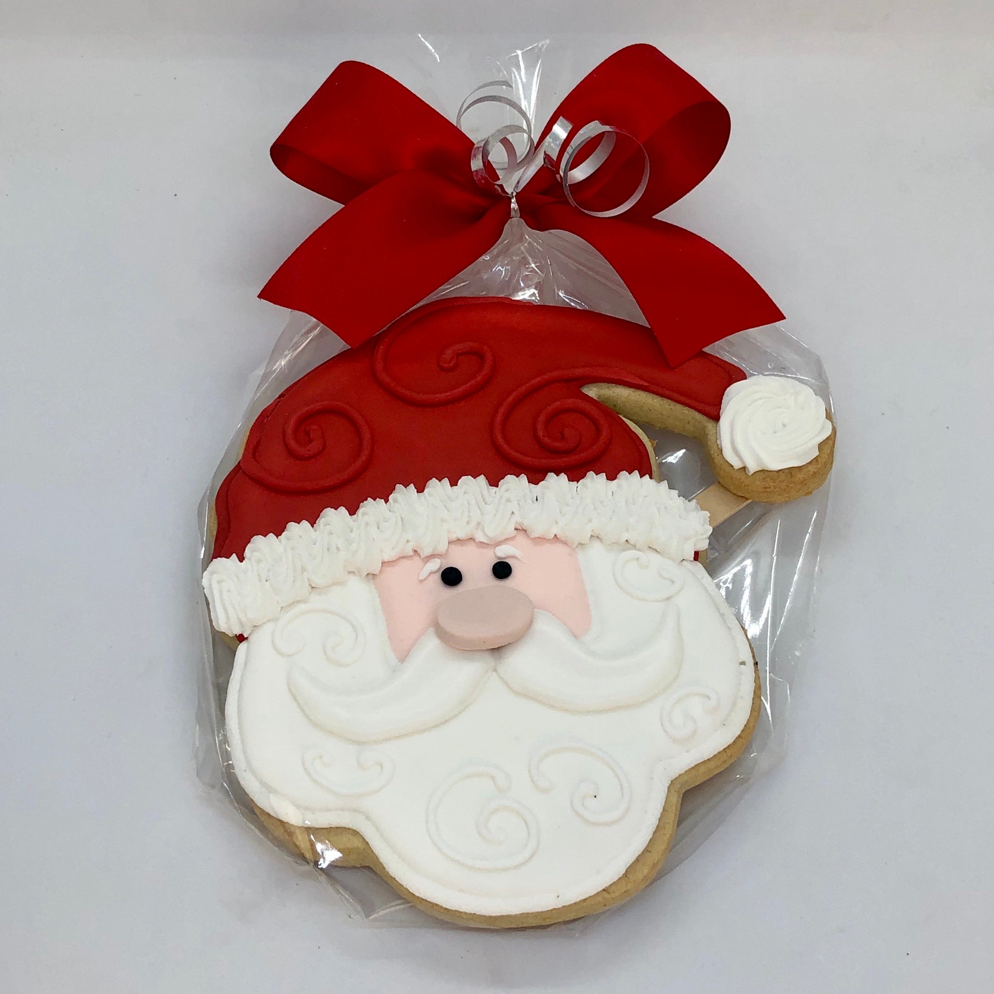 Santa Sugar Cookie wrapped in cellophane with a ribbon