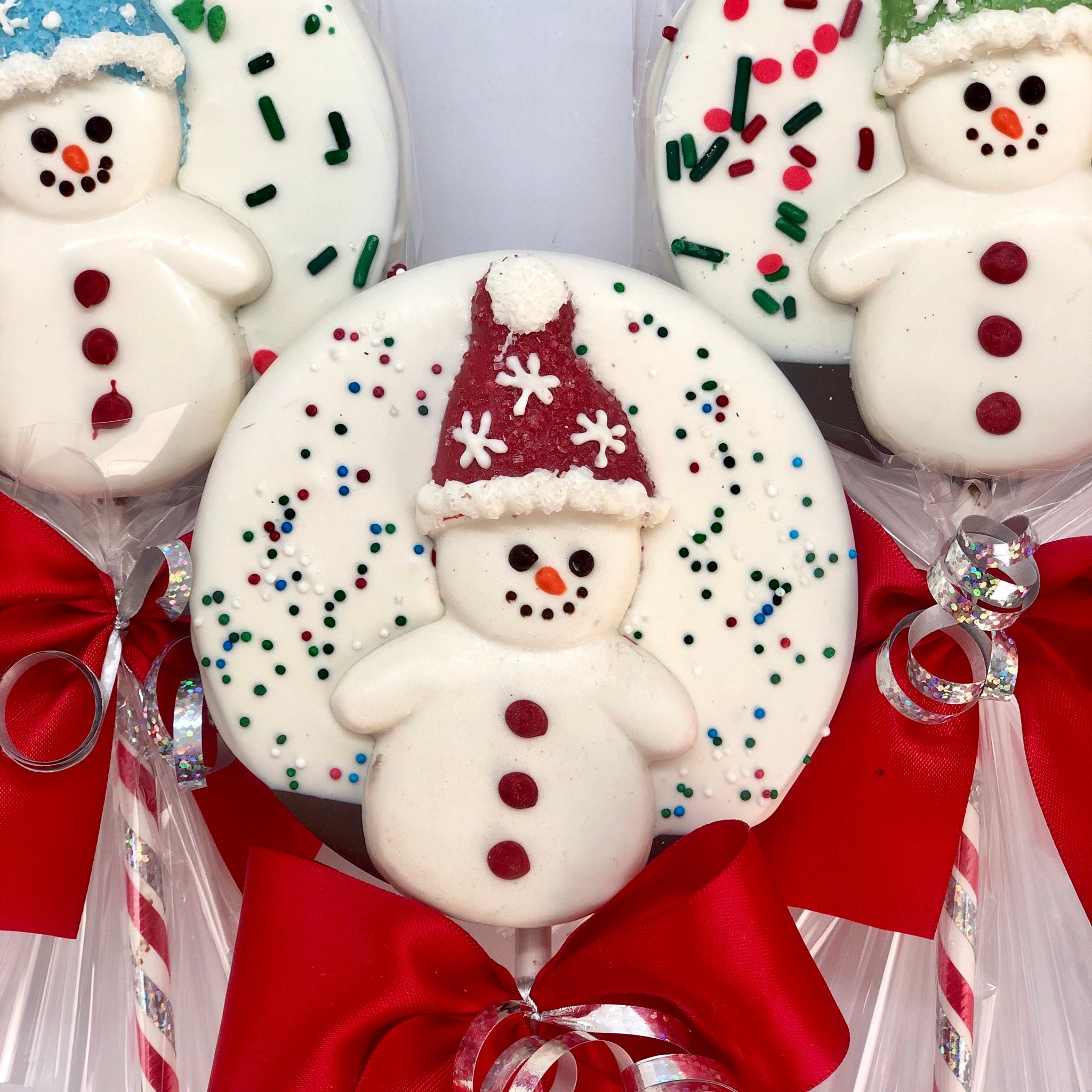 Snowman Chocolate Crispy Lollies wrapped in cellophane with a ribbon
