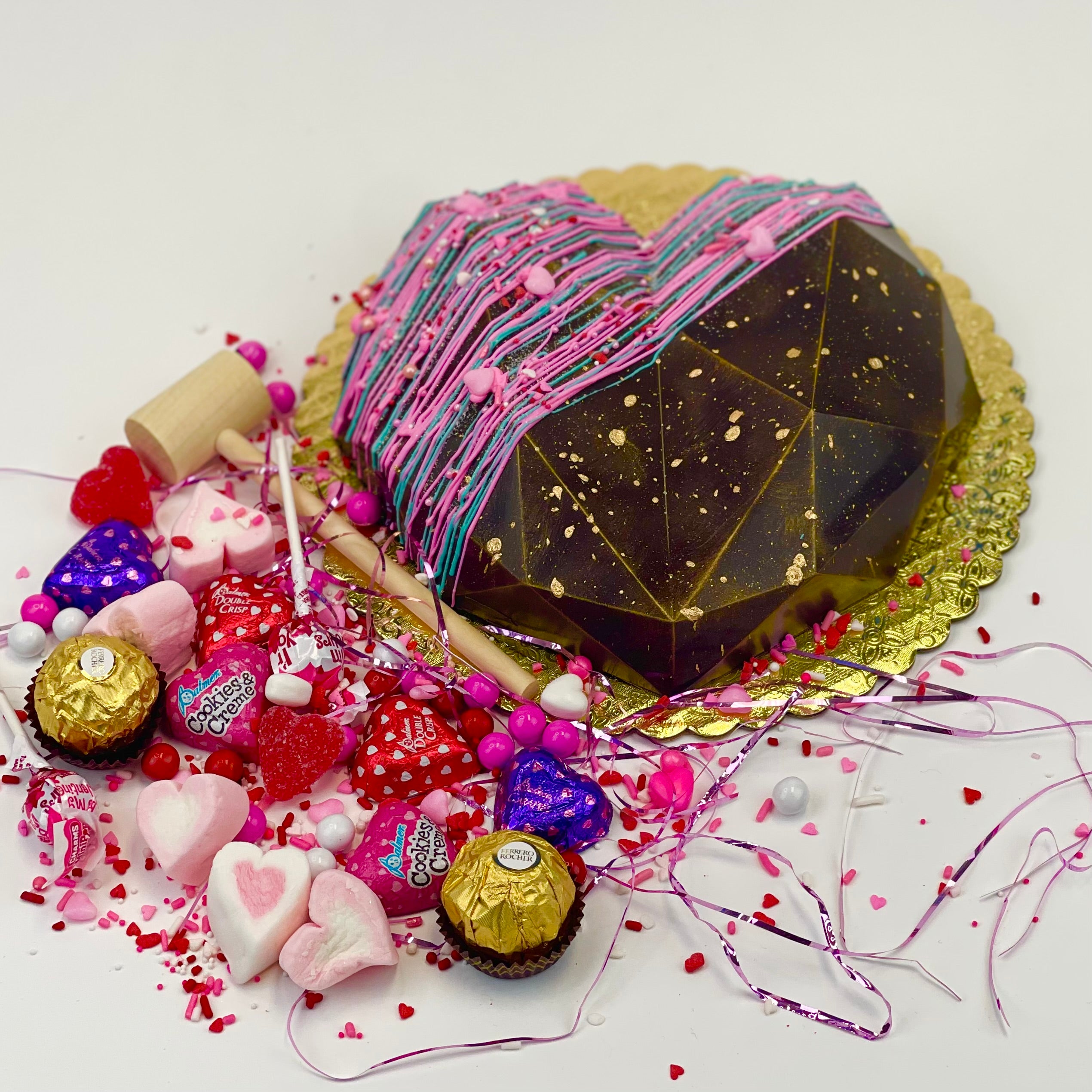 Candy-filled Chocolate geode heart, a wooden mallet, and some Valentine's candy